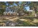 Backyard with mature trees and a large grassy area at 17852 Fancy Ln, Hudson, FL 34667