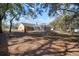 Spacious backyard with large trees, a screened pool, and a patio at 17852 Fancy Ln, Hudson, FL 34667