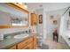 Bathroom with wood vanity, large mirror, and separate tub and shower at 17852 Fancy Ln, Hudson, FL 34667