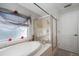 Bathroom with an enclosed shower and an oval bathtub at 17852 Fancy Ln, Hudson, FL 34667