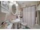 Clean bathroom with a pedestal sink, shower, and updated decor at 17852 Fancy Ln, Hudson, FL 34667