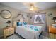 Beach-themed bedroom with a ceiling fan and light-colored furniture at 17852 Fancy Ln, Hudson, FL 34667