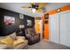 Relaxing bedroom with an orange accent wall and access to the hallway at 17852 Fancy Ln, Hudson, FL 34667