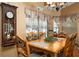 Bright dining area with wooden table and chairs, offering ample space at 17852 Fancy Ln, Hudson, FL 34667