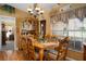 Charming dining room with a wooden hutch and large windows at 17852 Fancy Ln, Hudson, FL 34667
