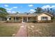 Single-story home with a large front porch and well-manicured lawn at 17852 Fancy Ln, Hudson, FL 34667