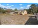 Side view of a single-story house with a large backyard at 17852 Fancy Ln, Hudson, FL 34667