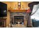 Stone fireplace with built-in shelving and mantle, adding warmth and charm at 17852 Fancy Ln, Hudson, FL 34667