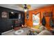 Fun game room features a large TV, guitars, and comfy seating at 17852 Fancy Ln, Hudson, FL 34667