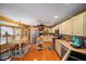 Open kitchen with an island, breakfast nook, and hardwood floors at 17852 Fancy Ln, Hudson, FL 34667
