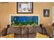 Built-in aquarium, brown leather couch and yellow throw pillows at 17852 Fancy Ln, Hudson, FL 34667