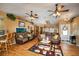 Spacious living room featuring hardwood floors, a large fish tank, and comfortable seating at 17852 Fancy Ln, Hudson, FL 34667