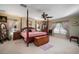 Large main bedroom with a four-poster bed, and ample natural light at 17852 Fancy Ln, Hudson, FL 34667
