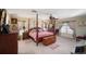 Main bedroom with a four poster bed and ample closet space at 17852 Fancy Ln, Hudson, FL 34667