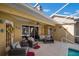 Relaxing patio area with wicker furniture and access to the pool at 17852 Fancy Ln, Hudson, FL 34667