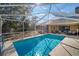 Inviting screened-in pool with a spacious deck and lush landscaping at 17852 Fancy Ln, Hudson, FL 34667