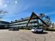 Exterior of a light teal condominium building with a unique architectural design at 2042 Australia W Way # 78, Clearwater, FL 33763