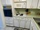 White kitchen with built-in oven, stovetop, and microwave at 2042 Australia W Way # 78, Clearwater, FL 33763