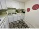 Bright kitchen featuring white cabinets and a dishwasher at 2042 Australia W Way # 78, Clearwater, FL 33763
