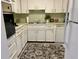 Galley-style kitchen with white cabinets and appliances at 2042 Australia W Way # 78, Clearwater, FL 33763