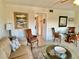 Living area with a sofa, chairs, and a glass-top dining table at 2042 Australia W Way # 78, Clearwater, FL 33763