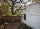 Backyard with wooden fence and mature trees at 307 E Althea Ave, Tampa, FL 33612