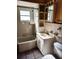 Well-lit bathroom featuring a tub and vanity with a white finish, complemented by tiled walls at 320 24Th N St, St Petersburg, FL 33713