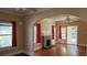 Bright living room with hardwood floors, brick fireplace and several windows with red curtains at 320 24Th N St, St Petersburg, FL 33713