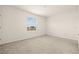 Bright bedroom with neutral carpeting and large window at 34395 Sorrel Mint Dr, Wesley Chapel, FL 33543