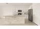 Modern kitchen with white cabinets, granite countertops, and island at 34395 Sorrel Mint Dr, Wesley Chapel, FL 33543