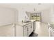 Kitchen island with granite countertop and sink overlooking living room at 34395 Sorrel Mint Dr, Wesley Chapel, FL 33543