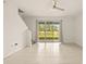 Bright living room with tile floors and sliding glass doors to backyard at 34395 Sorrel Mint Dr, Wesley Chapel, FL 33543