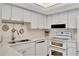 Modern white kitchen with stainless steel appliances at 400 Island Way # 903, Clearwater Beach, FL 33767