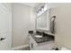 Bathroom boasts a white vanity with dark granite countertop and a large mirror at 4221 W Spruce St # 1404, Tampa, FL 33607