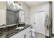 Modern bathroom with a walk-in shower, granite countertop, and a large mirror at 4221 W Spruce St # 1404, Tampa, FL 33607