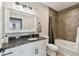 Modern bathroom with dark granite countertop, white cabinets, and a bathtub at 4221 W Spruce St # 1404, Tampa, FL 33607