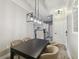 Dining area with four chairs and modern light fixture at 4221 W Spruce St # 1404, Tampa, FL 33607
