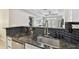 Modern kitchen with granite countertops and a view of the dining area at 4221 W Spruce St # 1404, Tampa, FL 33607