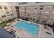 Aerial view of community pool with surrounding lounge chairs and patio furniture at 4221 W Spruce St # 1404, Tampa, FL 33607