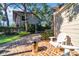 Brick patio with seating area, fire pit and beautiful landscaping at 4307 W Kensington Ave, Tampa, FL 33629