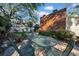 Outdoor patio area with metal table and chairs under shade trees at 4307 W Kensington Ave, Tampa, FL 33629