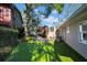 Spacious backyard oasis with brick patio, lush lawn, and mature trees at 4307 W Kensington Ave, Tampa, FL 33629
