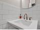 Clean bathroom with white subway tile and copper fixtures at 4307 W Kensington Ave, Tampa, FL 33629