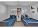 Well-lit bedroom featuring two twin beds and ample closet space at 4307 W Kensington Ave, Tampa, FL 33629