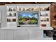 White built-in entertainment center, TV, and shelving at 4307 W Kensington Ave, Tampa, FL 33629