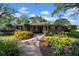 Brick ranch home with landscaped yard and walkway at 4307 W Kensington Ave, Tampa, FL 33629