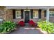 Front entrance with black door and poinsettias at 4307 W Kensington Ave, Tampa, FL 33629