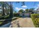 Detached garage with driveway and lush landscaping at 4307 W Kensington Ave, Tampa, FL 33629