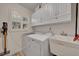 Laundry room with washer, dryer, cabinets, and sink at 4307 W Kensington Ave, Tampa, FL 33629