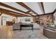 Large living room with exposed beams, a fireplace, and ample seating at 4307 W Kensington Ave, Tampa, FL 33629